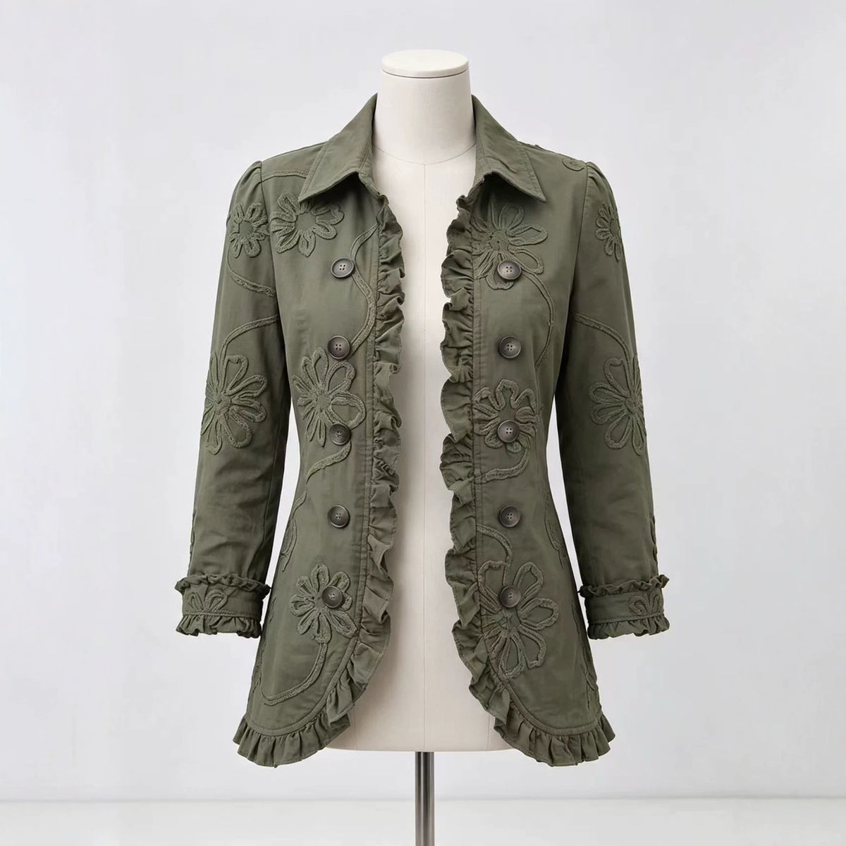 Olive collared jacket on a mannequin with floral detailing and ruffled hem