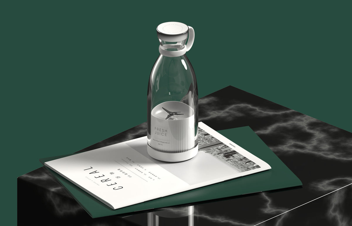 White portable blender with clear bottle and visible blades on a dark table