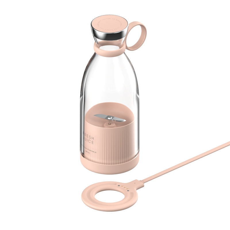Pink portable blender pictured with ring-shaped charging accessory