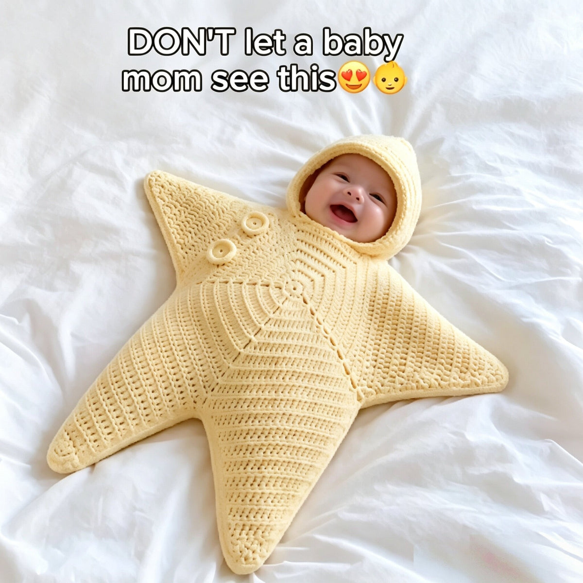 Baby pictured in a pale yellow hooded star-shaped crochet outfit with button detailing