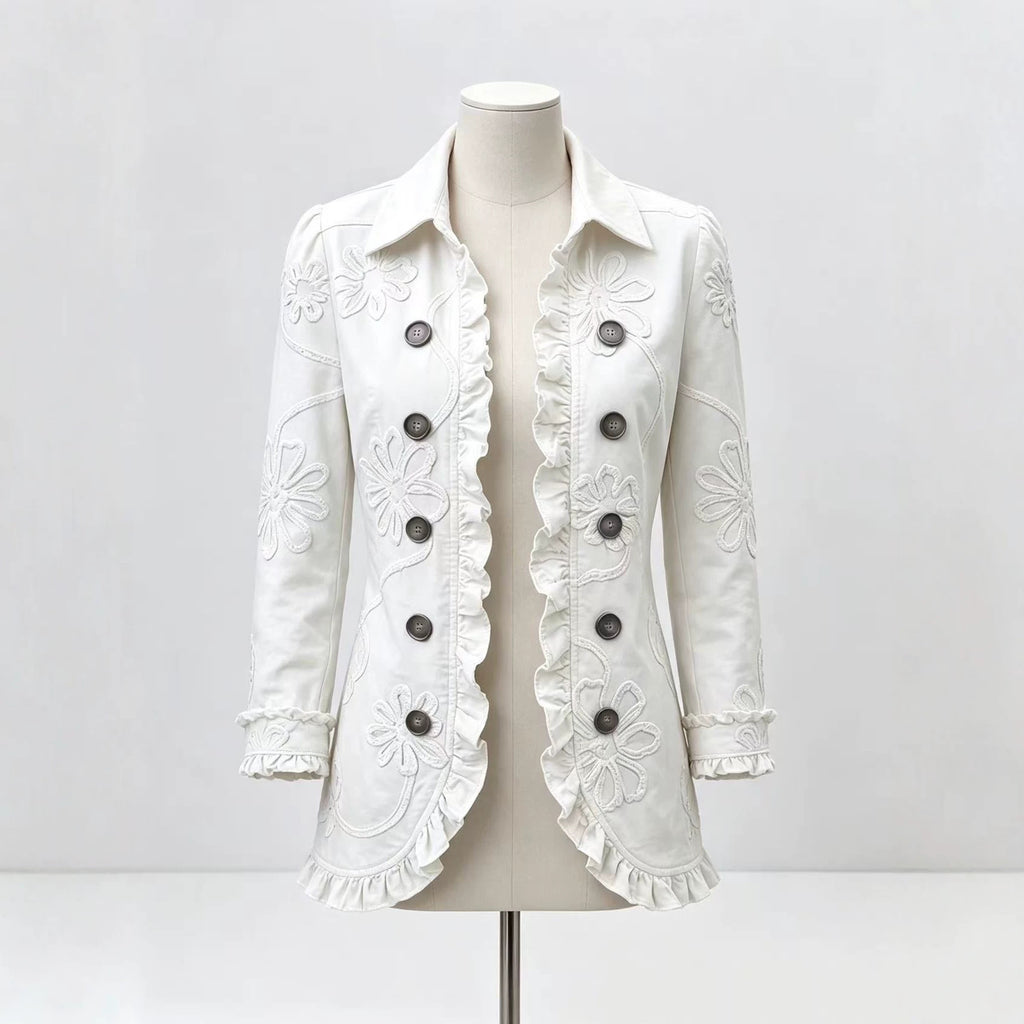 White collared jacket on a mannequin with floral detailing and ruffled edges