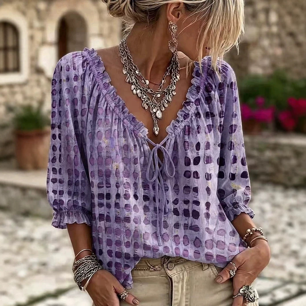 Purple printed blouse with ruffled neckline and gathered cuffs