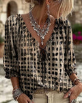 Black and beige printed blouse with ruffled neckline and front tie