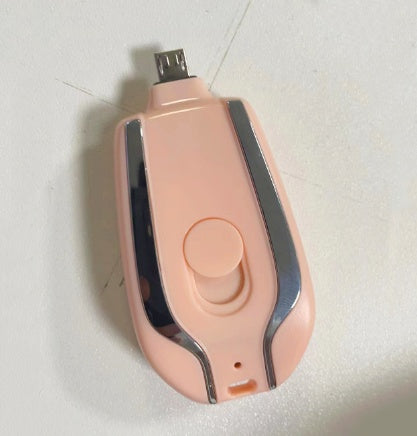 Pink miniature power bank showing built-in connector and sliding button