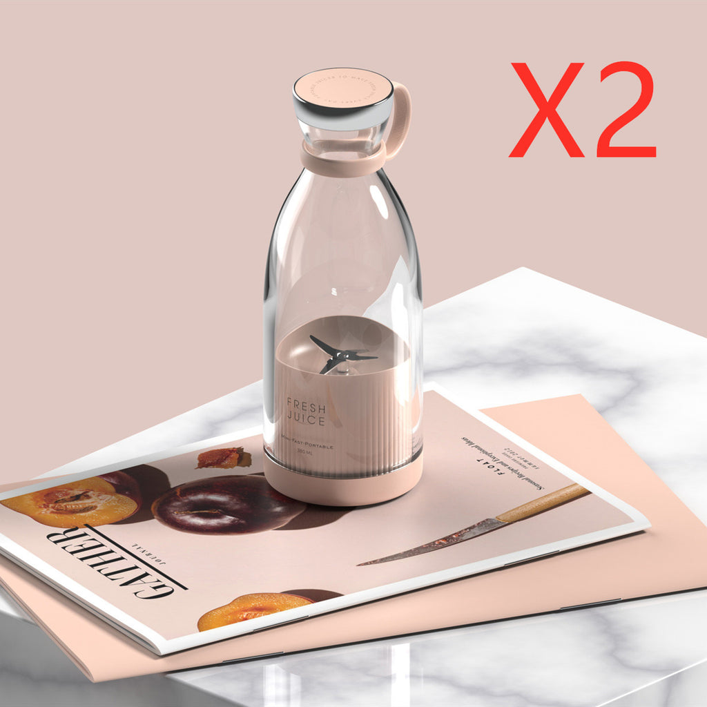 Pink portable blender on a magazine with an X2 label
