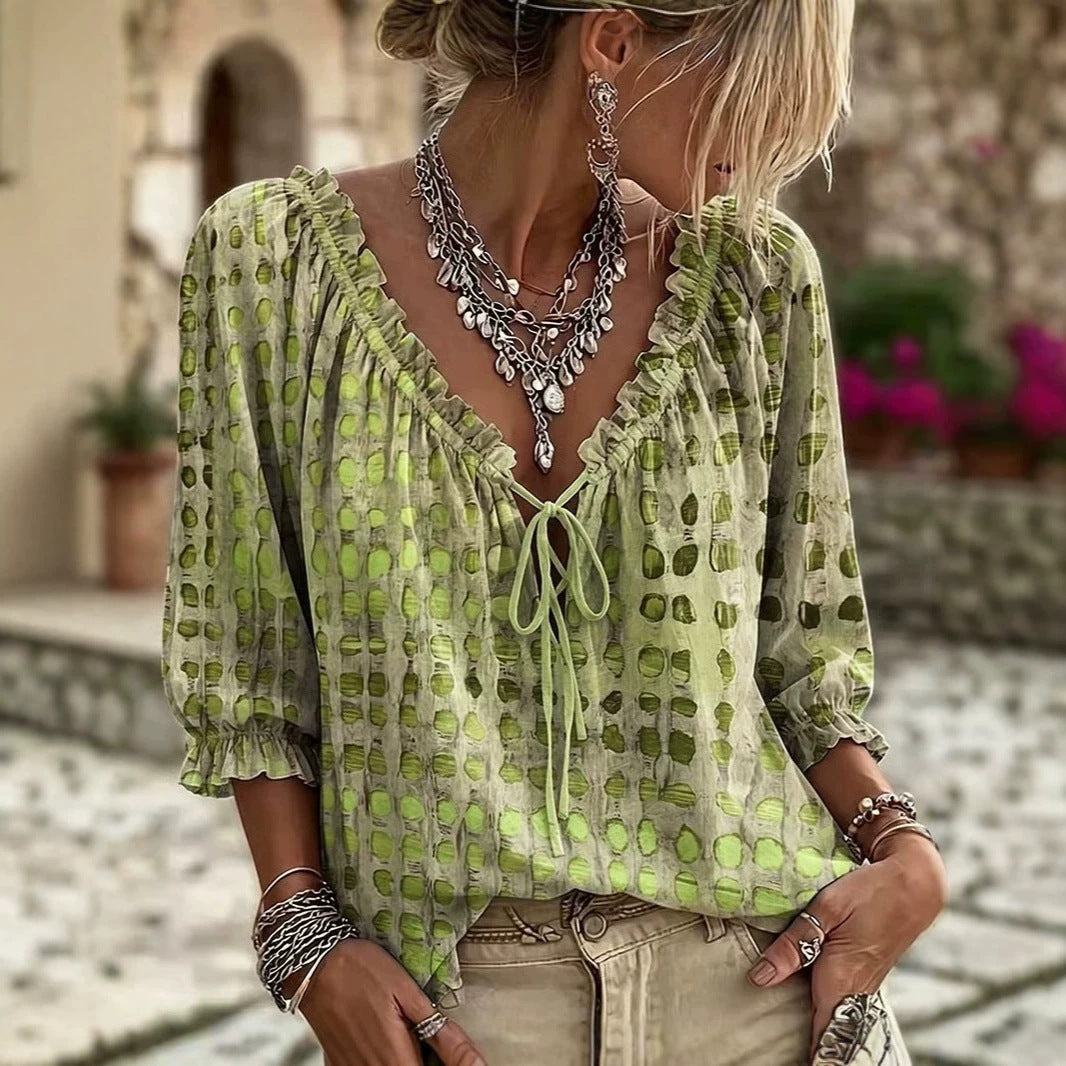 Light green printed tie-neck blouse with ruffled neckline and gathered sleeves