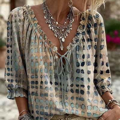 Cream and beige printed tie-neck blouse with ruffled cuffs