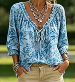 Light blue blouse with leafy print and ruffled tie neckline