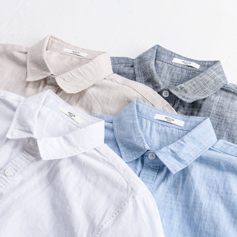 Close-up of white, light khaki, light blue and gray-blue shirt collars