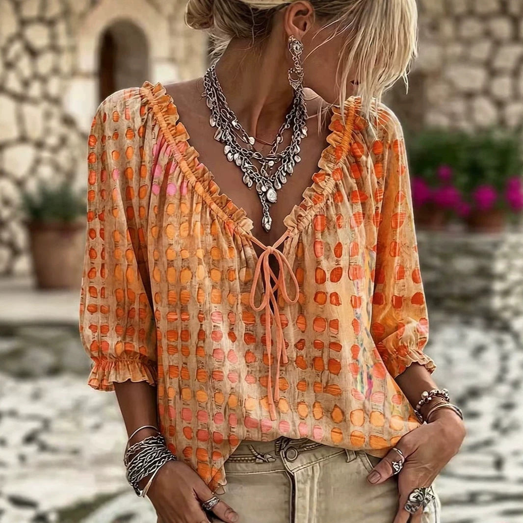 Orange and pink printed tie-neck blouse with ruffled neckline