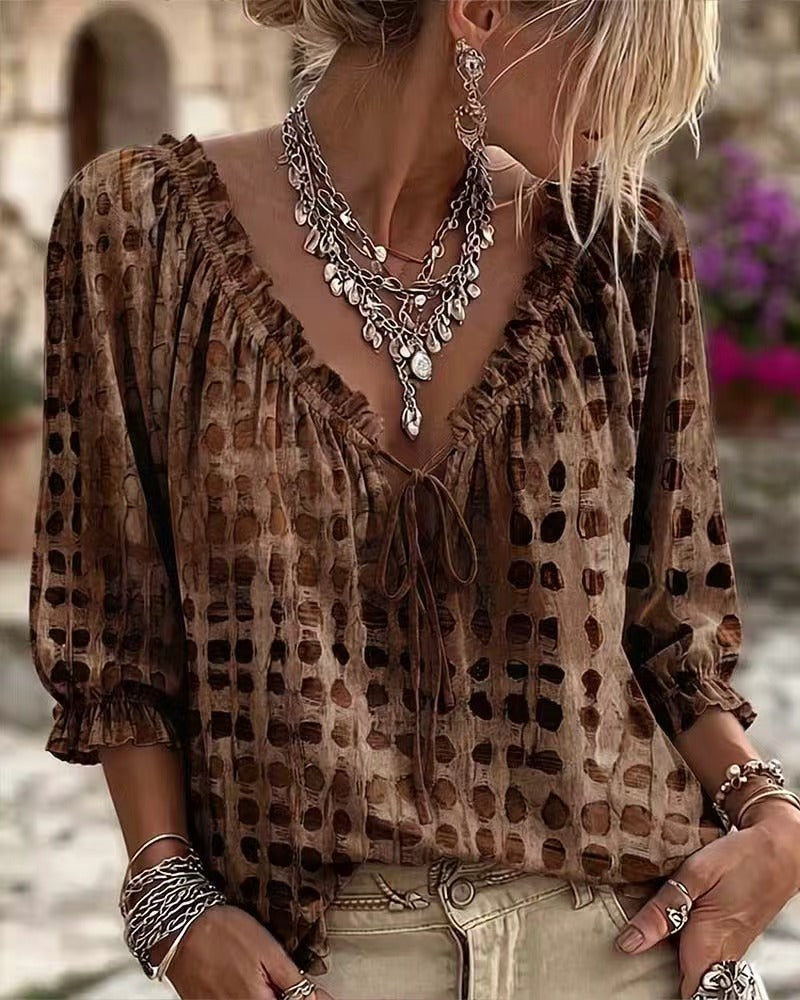 Brown printed tie-neck blouse with ruffled neckline and gathered cuffs