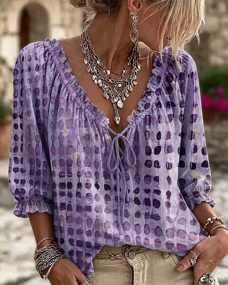 Purple printed blouse showing neckline ruffles and front tie