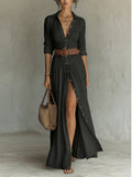 Black collared maxi shirt dress shown with a brown belt and handbag