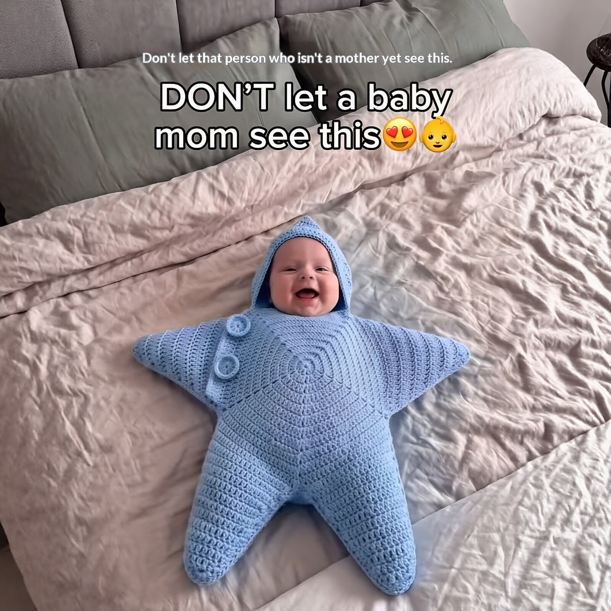 Baby pictured in a blue hooded star-shaped crochet outfit